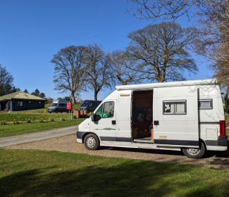 Campervan in Scottish campsite on a sunny day 