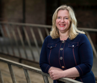 Caroline Millar standing in agricultural building